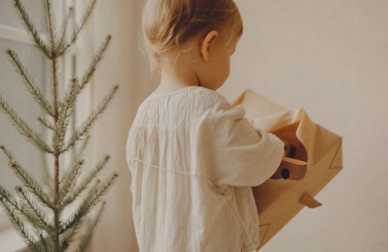 Cadeaux emballés dans du papier kraft au pied d'un sapin sobre