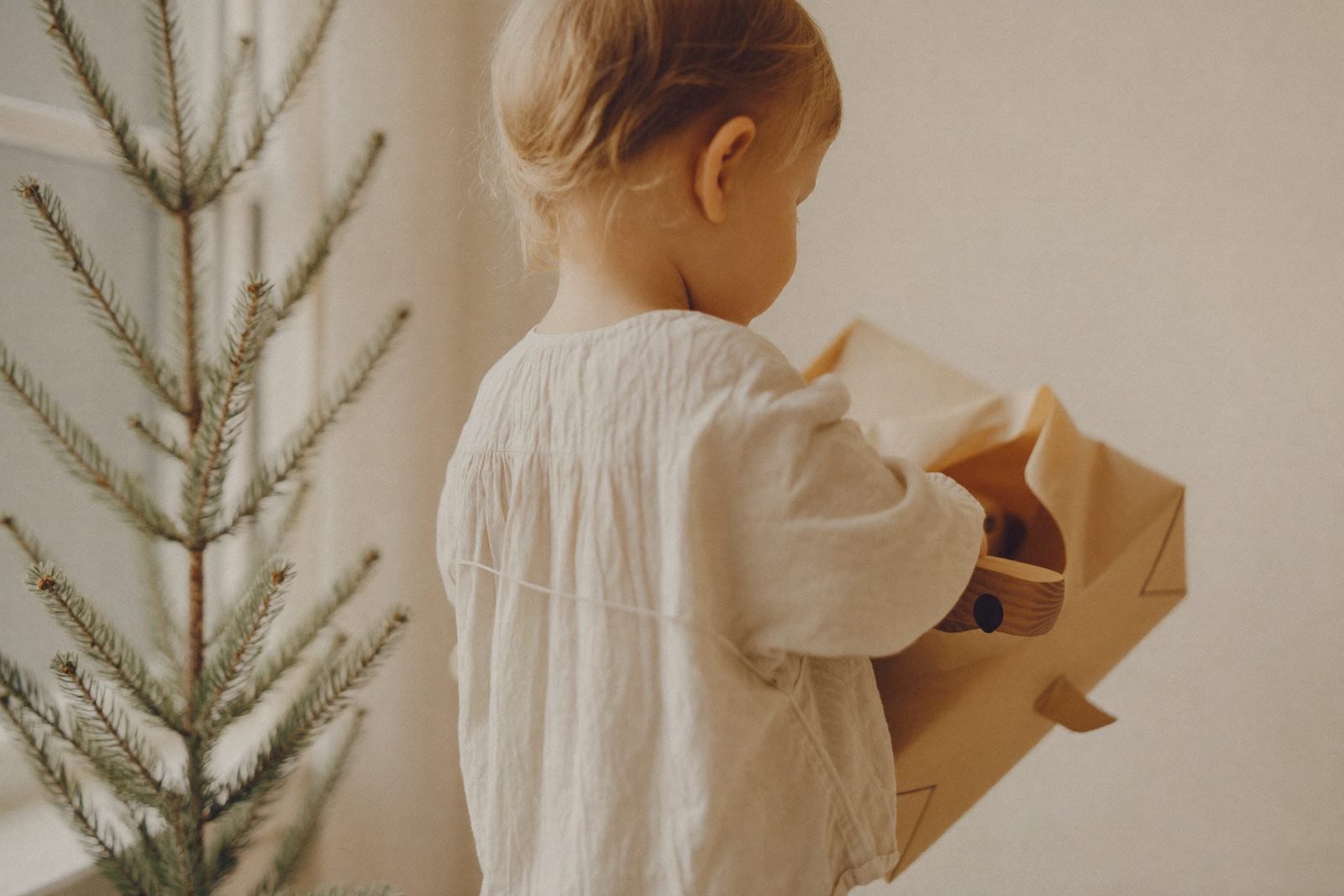 Cadeaux emballés dans du papier kraft au pied d'un sapin sobre